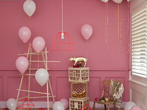 Pink_kids_room_nursery_gold_leaf_pig_ornament_balloons_timber_pole_tower_red_light_cage_tan_crate